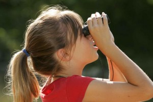 blonde-girl-watching-with-binoculars-725x483